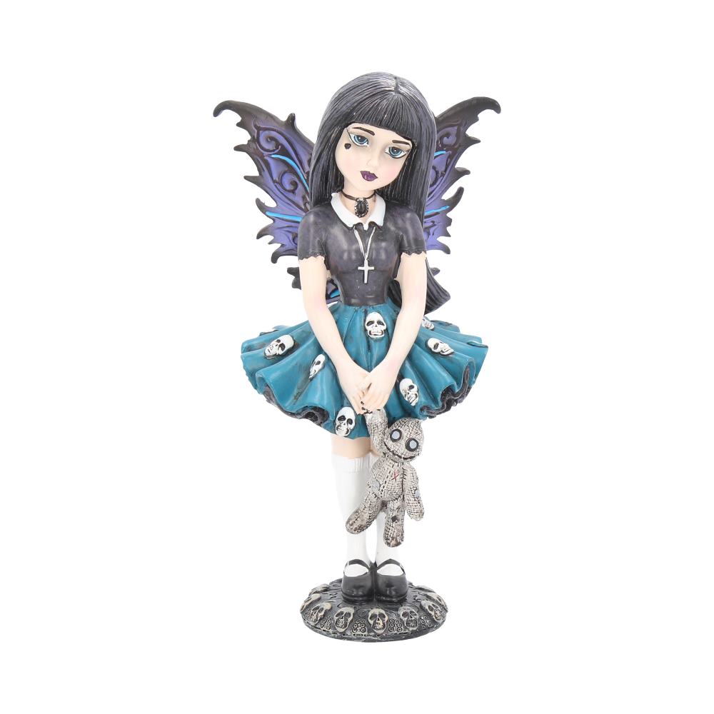 Noire stands on a plinth of skulls holding her stitched up teddy.