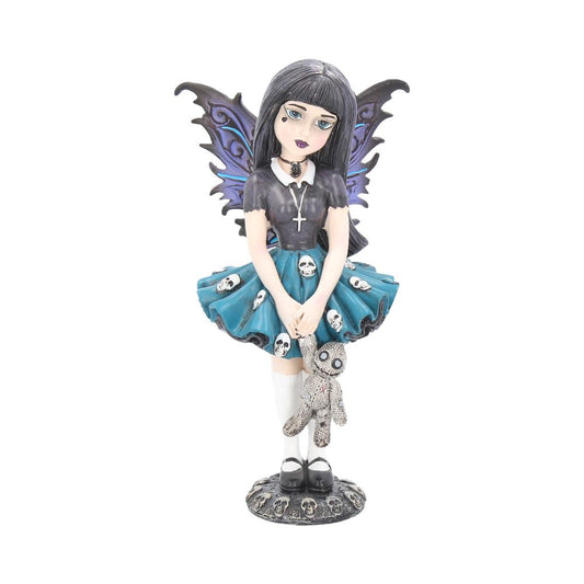 Noire stands on a plinth of skulls holding her stitched up teddy.