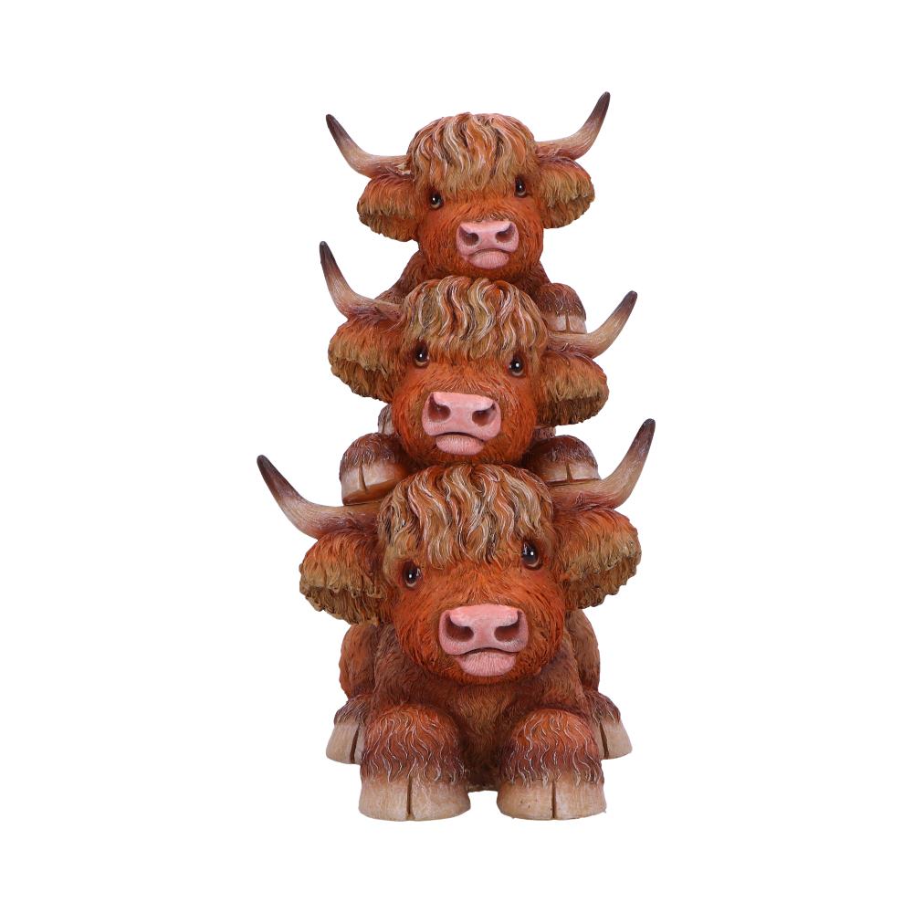 Figurine featuring three Highland Cows in totem pole formation