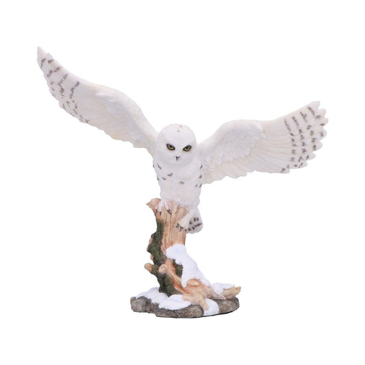 Winter owl sculpture on a tree branch dramatic wing pose