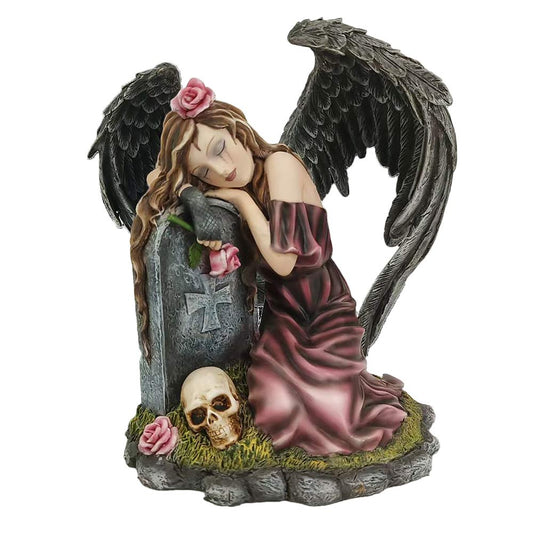 Resin figurine of a mourning angel resting beside a gravestone